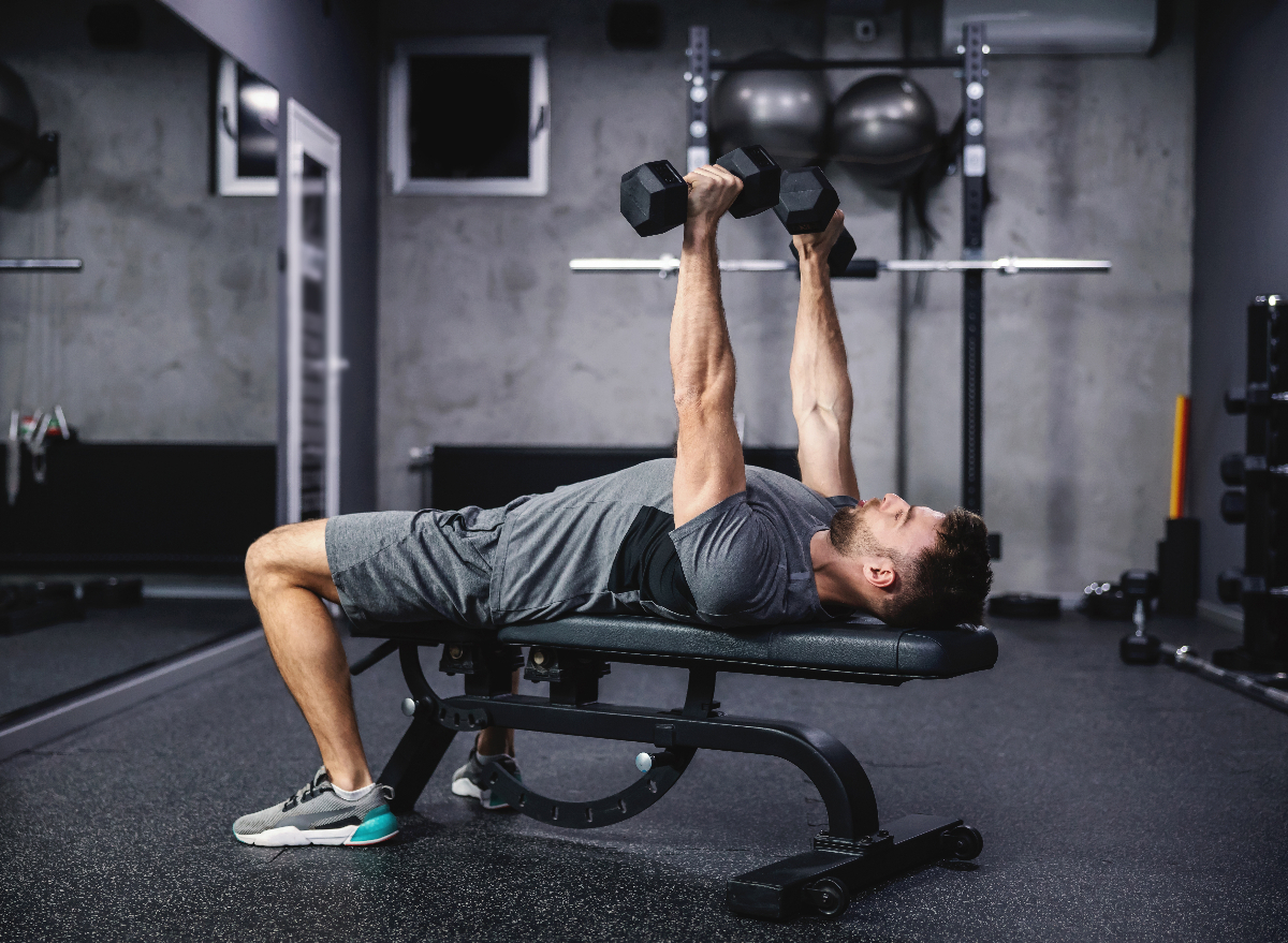 man doing dumbbell bench press
